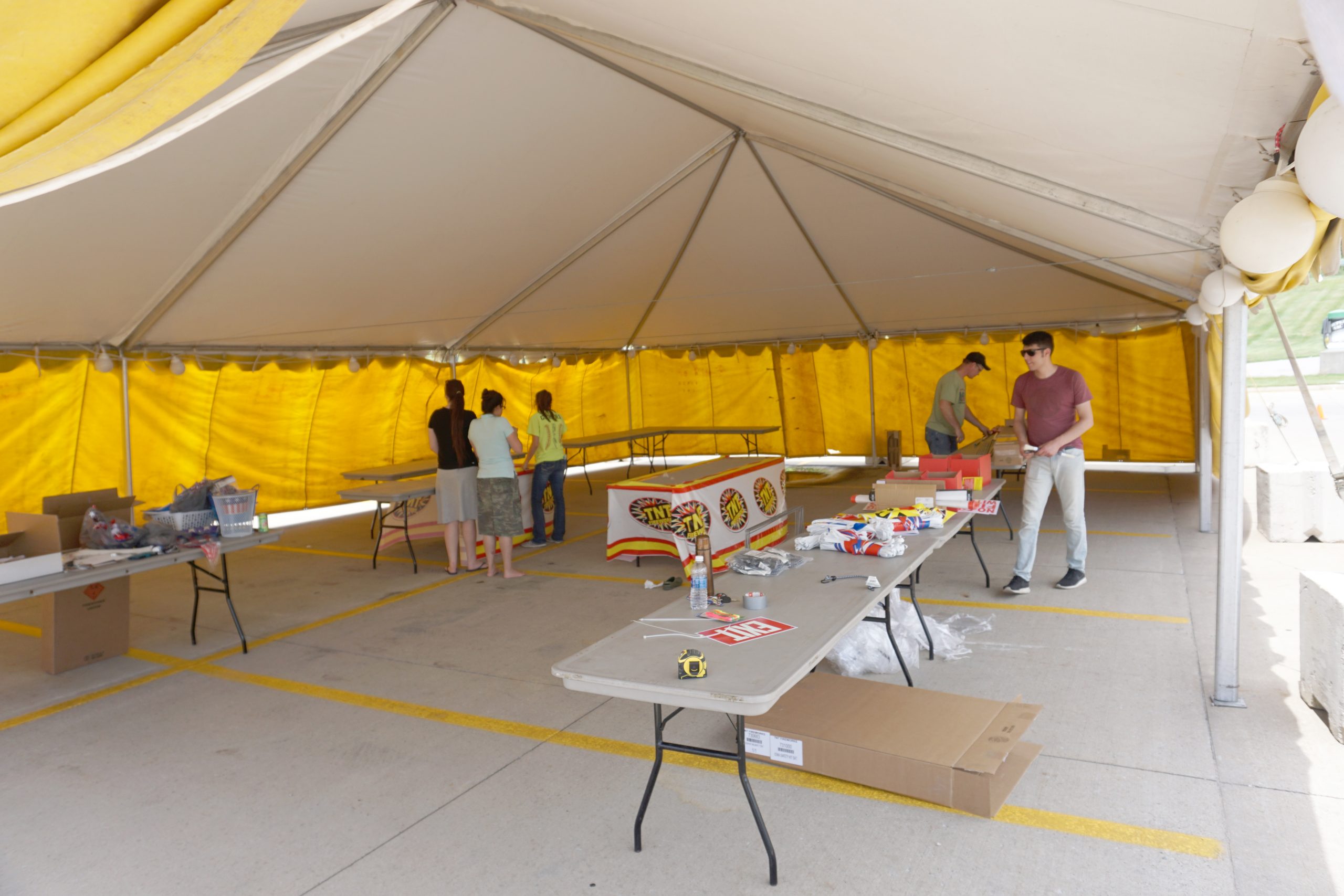 Setting up a fireworks stand at Walmart Supercenter in Iowa City, IA under a 30' x 45' frame tent