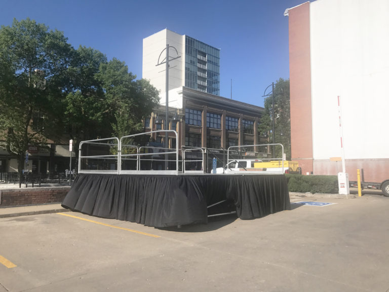 Setup of a 16' x 16' stage on 48 legs in downtown Iowa City for the Iowa City Block Party in 2017