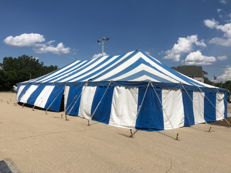 Side of the 30' x 60' blue and white rope and pole tent for Fireworks Stand setup in Clinton, Iowa