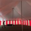 Under a 40' x 60' rope and pole tent with Red and White Sidewall used for Fireworks tent at Hy-Vee in Cedar Rapids, Iowa
