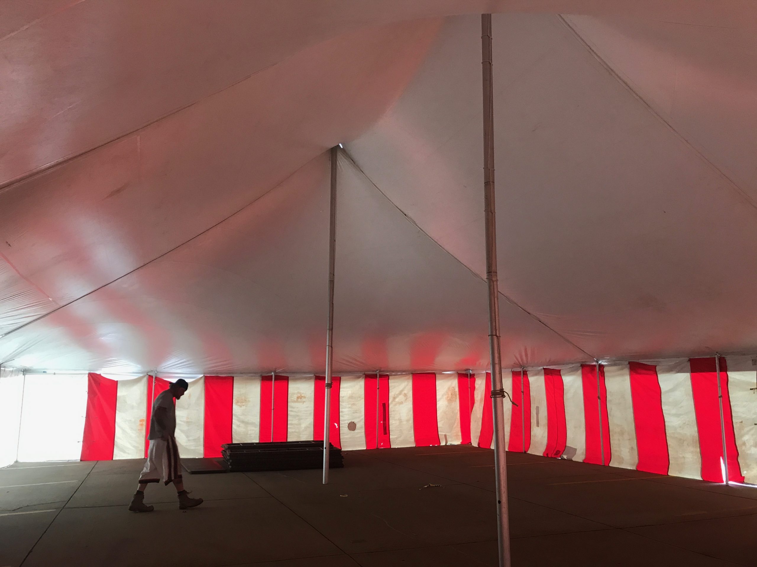 Under a 40' x 60' rope and pole tent with Red and White Sidewall used for Fireworks tent at Hy-Vee in Cedar Rapids, Iowa