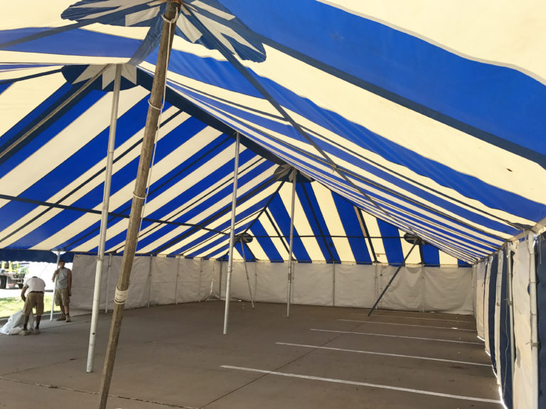 Under the 40' x 70' blue and white rope and pole fireworks tent at Hy-Vee S. 1st Ave in Iowa City for Bellino Fireworks