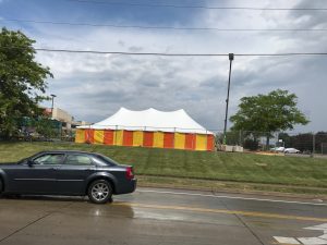 View from the road of our 30' x 60' rope and pole tent at Hy-Vee 1823 E Kimberly Rd in Davenport, Iowa with Yellow and Orange side walls