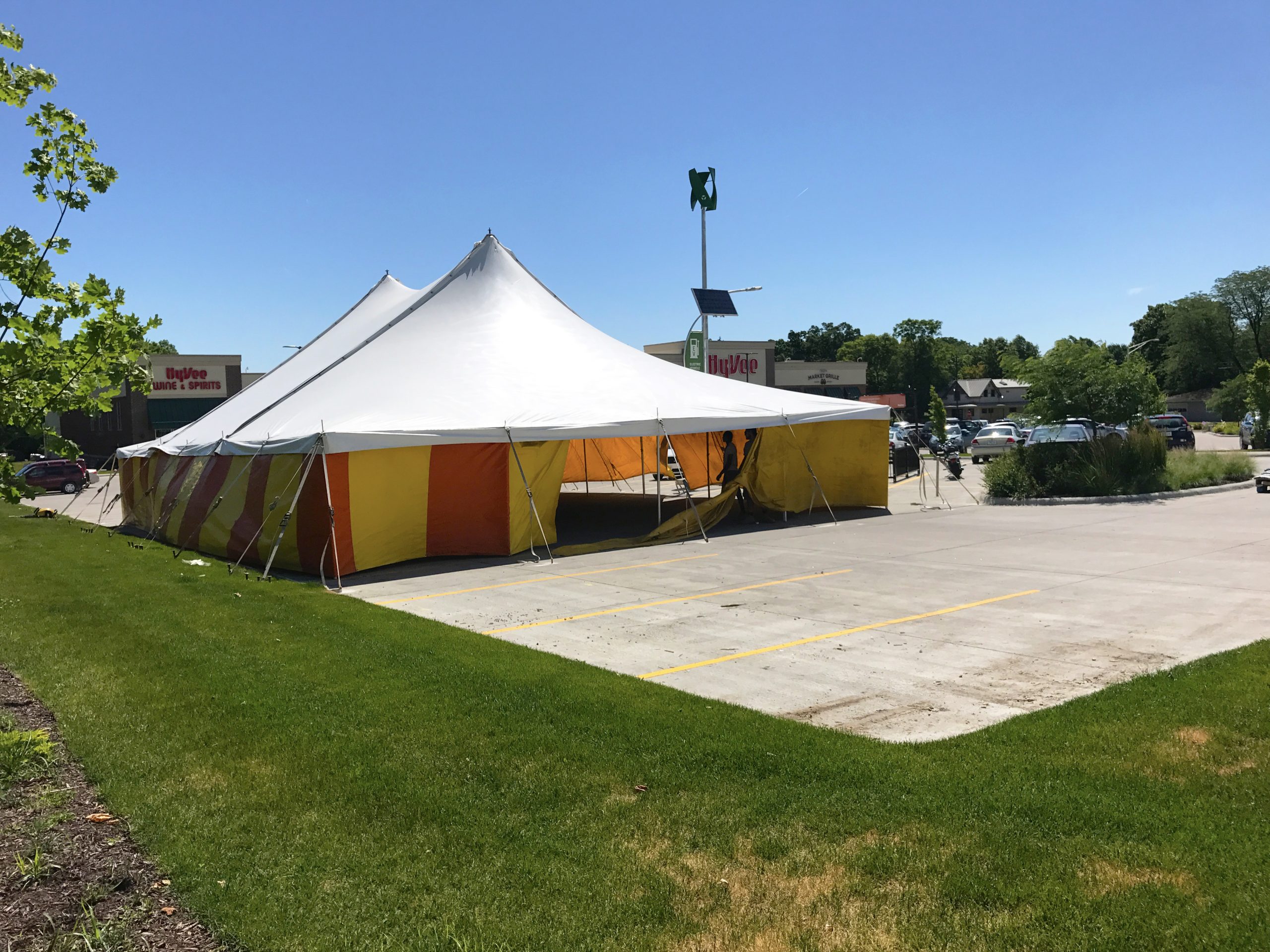 View of the parking lot at HyVee on Dodge St. in Iowa City with 40' x 60' rope and pole tent for Bellino Fireworks