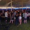 Lots of people under the 60′ x 150′ “twin pole” Legend rope and pole tent at Blues and BBQ in North Libery, Iowa