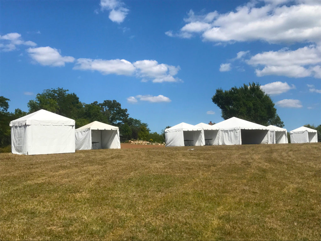 10' x 10' frame tents with one 20' x 20' frame tent at Outdoor corporate event setup for West Liberty foods in Libertyville, Iowa