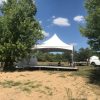20' x 20' Tentnology frane tent on top of stage for an Outdoor corporate event setup for West Liberty foods in Libertyville, Iowa