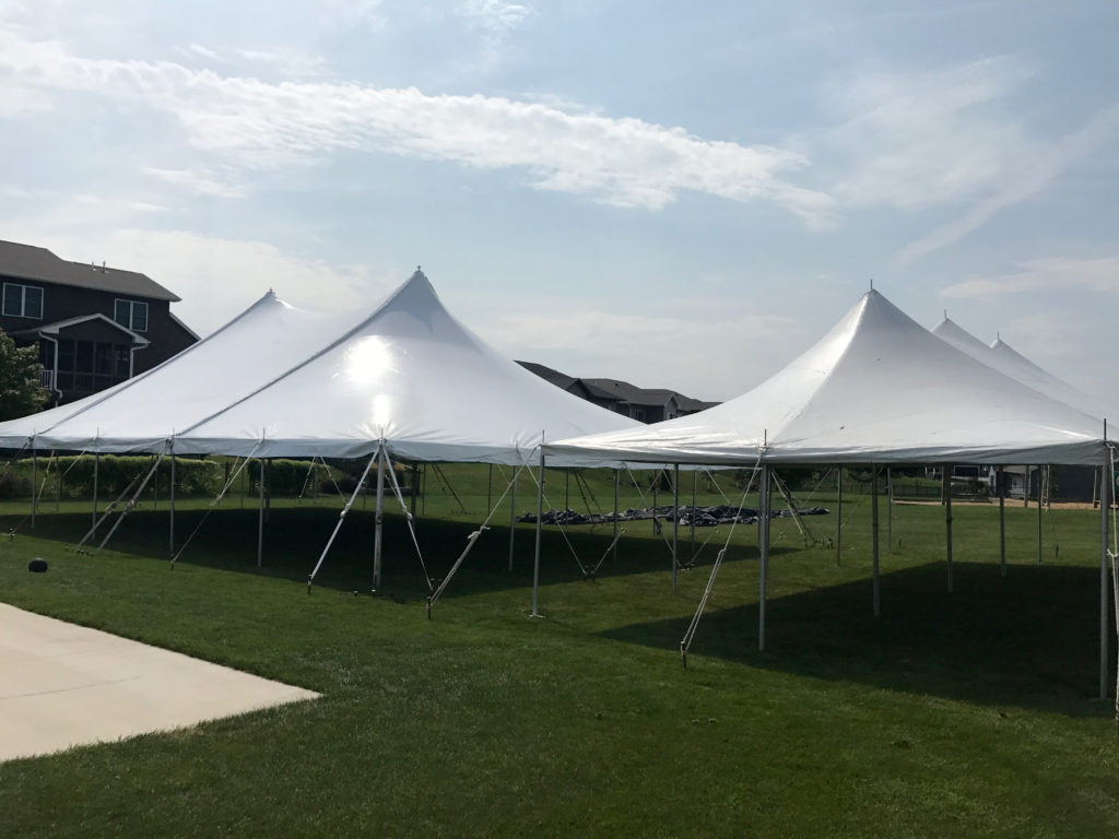 Block party setup with 40' x 60' rope and pole on the left and 20' x 40 rope and pole tent on the right