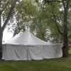 End of 30' x 60' rope and pole wedding tent with white sides Monticello, IA surrounded by trees