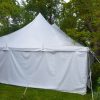 End of the 30' x 60' rope and pole tent with white sides Monticello, IA surrounded by trees