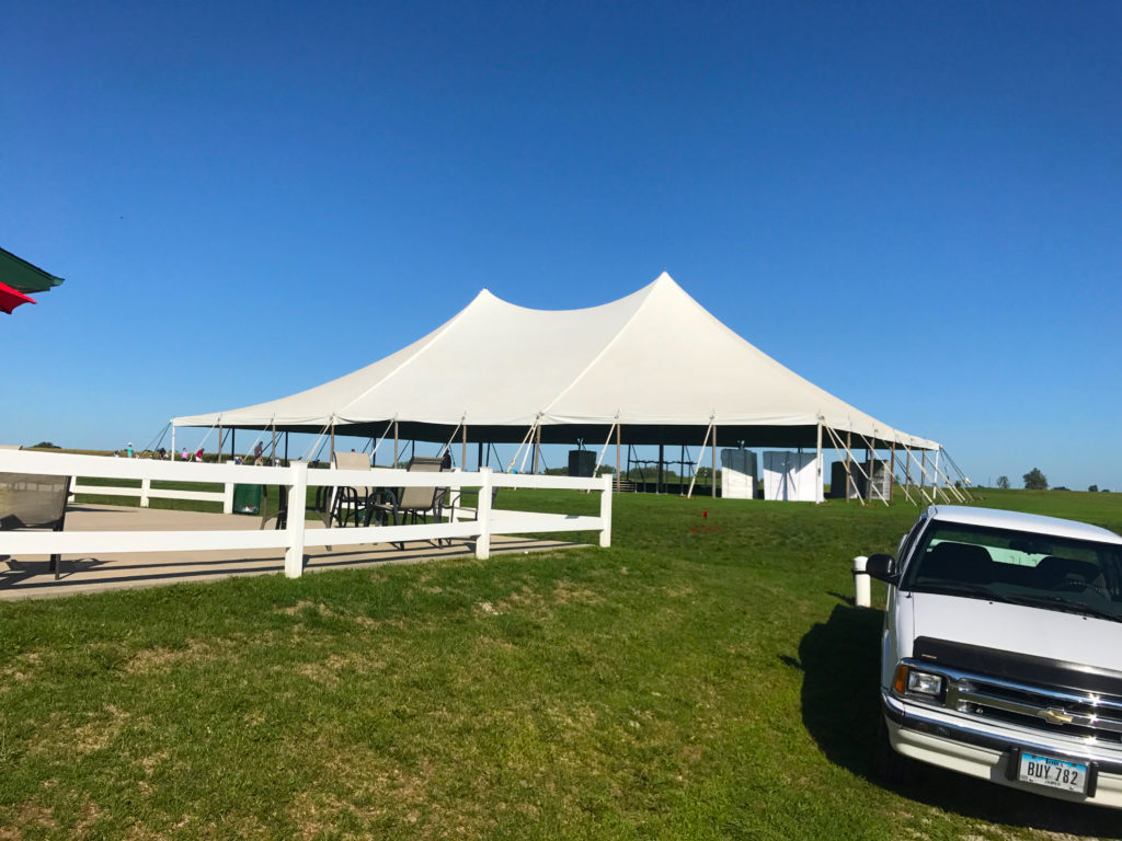 Outside of a white 60' x 90' rope and pole tent for a Wedding Reception in Newton, Iowa