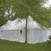 Side of 30' x 60' rope and pole wedding tent with white sides Monticello, IA surrounded by trees