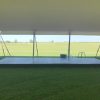 Small stage under the white 60' x 90' rope and pole tent
