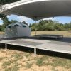 Stage with tent set up on top of it for Outdoor corporate event setup for West Liberty foods in Libertyville, Iowa