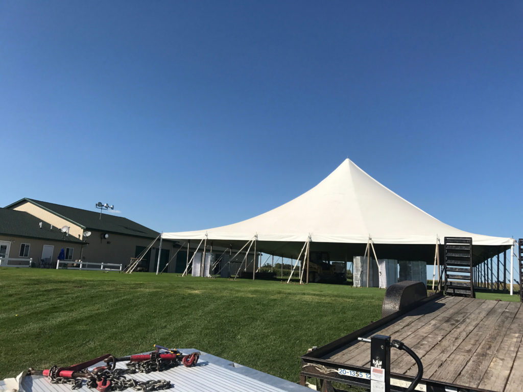 White 60' x 90' rope and pole tent for a wedding in Newton, Iowa