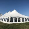 Corner of 40' x 80' rope and pole wedding tent setup in Fairfield, Iowa