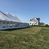 Side of 40' x 80' rope and pole wedding tent setup in Fairfield, Iowa with home