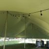 Under a 40' x 80' rope and pole tent at a campground near Muscatine, Iowa