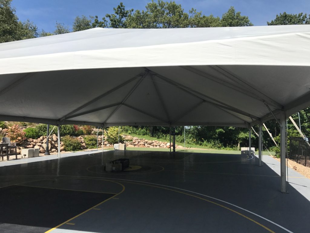 Under the 40' x 60' hybrid event tent setup on a Basketball court in Coralville, IA