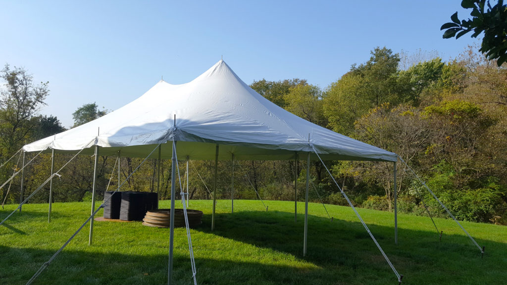Backyard with a white 20' x 30' rope and pole tent