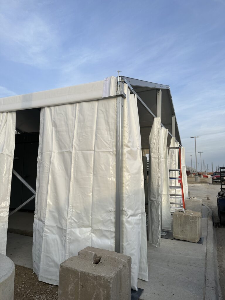 Temporary 30' x 30' Clearspan Tent Structure in Des Moines for Baker Electric over Siemens equipment with sidewalls and blocks