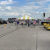 20' x 20' yellow and white frame tent at the Quad city air show set up by Big Ten Rentals