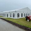 18m x 35m (60′ x 114′) Losberger clearspan temporary event structure with doors set up for a wedding reception