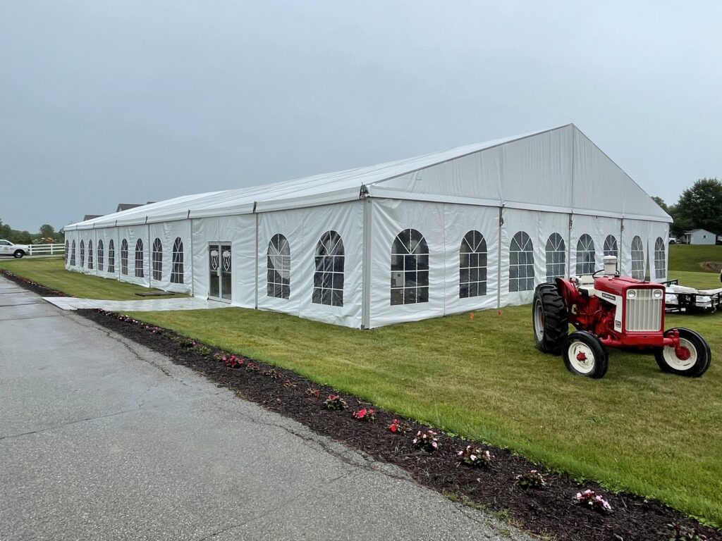 18m x 35m (60′ x 114′) Losberger clearspan temporary event structure with doors set up for a wedding reception