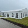 18m x 35m (60′ x 114′) Losberger clearspan temporary event structure with doors set up for an at home wedding reception