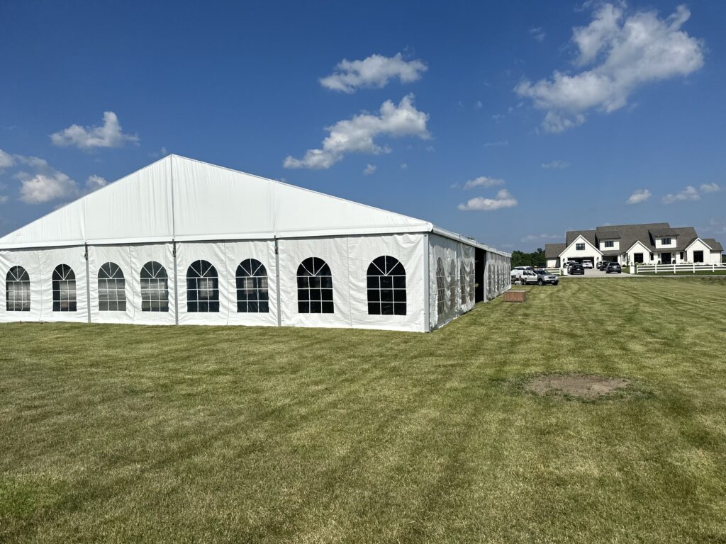 Field with 18m x 35m (60′ x 114′) Losberger clearspan temporary event tent structure for a wedding reception in Iowa City near Solon, IA