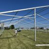 Finished beams of a 18m x 35m (60′ x 114′) Losberger clearspan temporary event tent structure for a wedding reception in Iowa City near Solon, IA