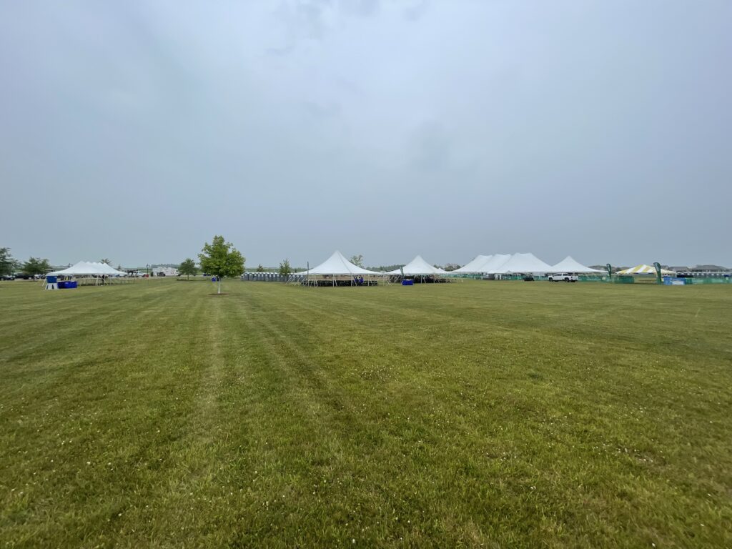 From left to right 20′ x 60′ Rope and Pole Tent, two 40′ x 40′ Rope and Pole Tents, 80′ x 120′ Rope and Pole Tent, 40′ x 40′ Rope and Pole Tent, and a 20′ x 20′ Frame Tent on the right