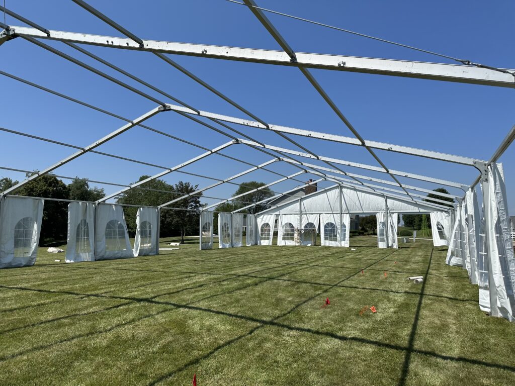 Sidewalls added to the beams of a 18m x 35m (60′ x 114′) Losberger clearspan temporary event tent structure for a wedding reception in Iowa City near Solon, IA