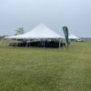 Tables and chairs under a 40′ x 40′ Rope and Pole tent