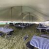 Tables and chairs under the 80′ x 120′ Rope and Pole tent at Blues and BBQ in North Liberty, IA