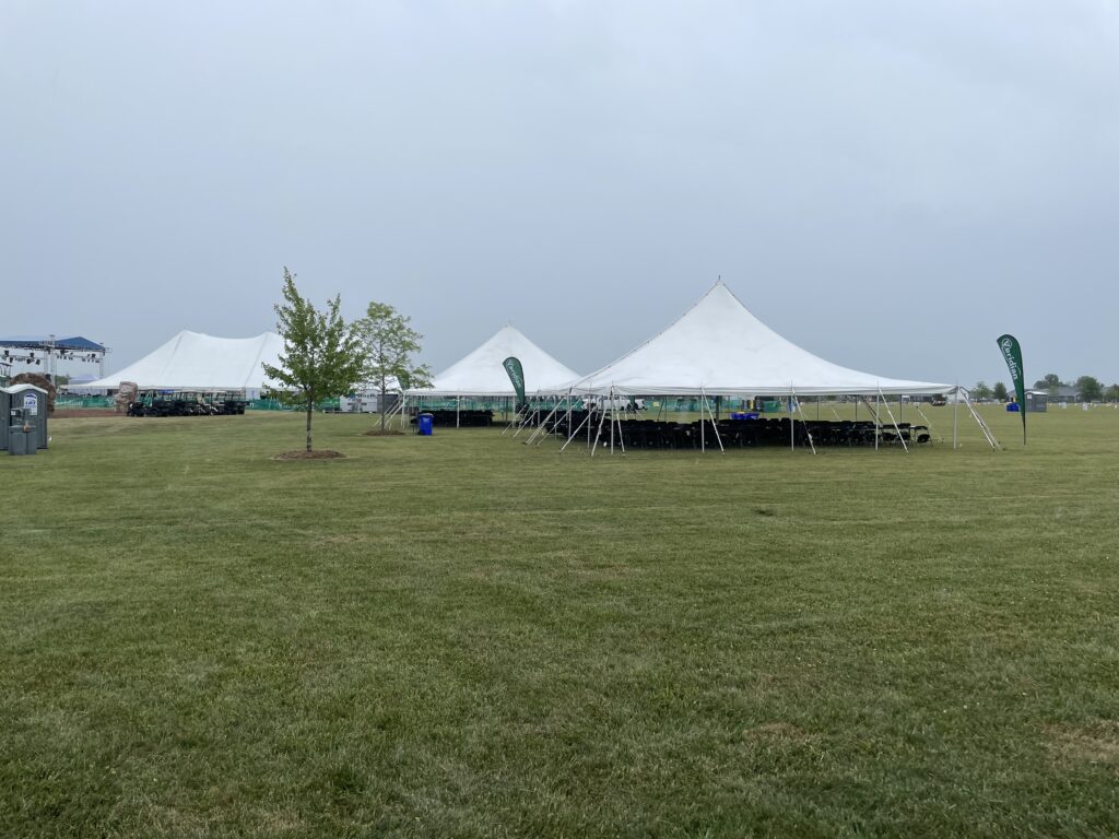 Two 40′ x 40′ Rope and Pole Tents on the right and one 80′ x 120′ Rope and Pole Tent in the background on the left