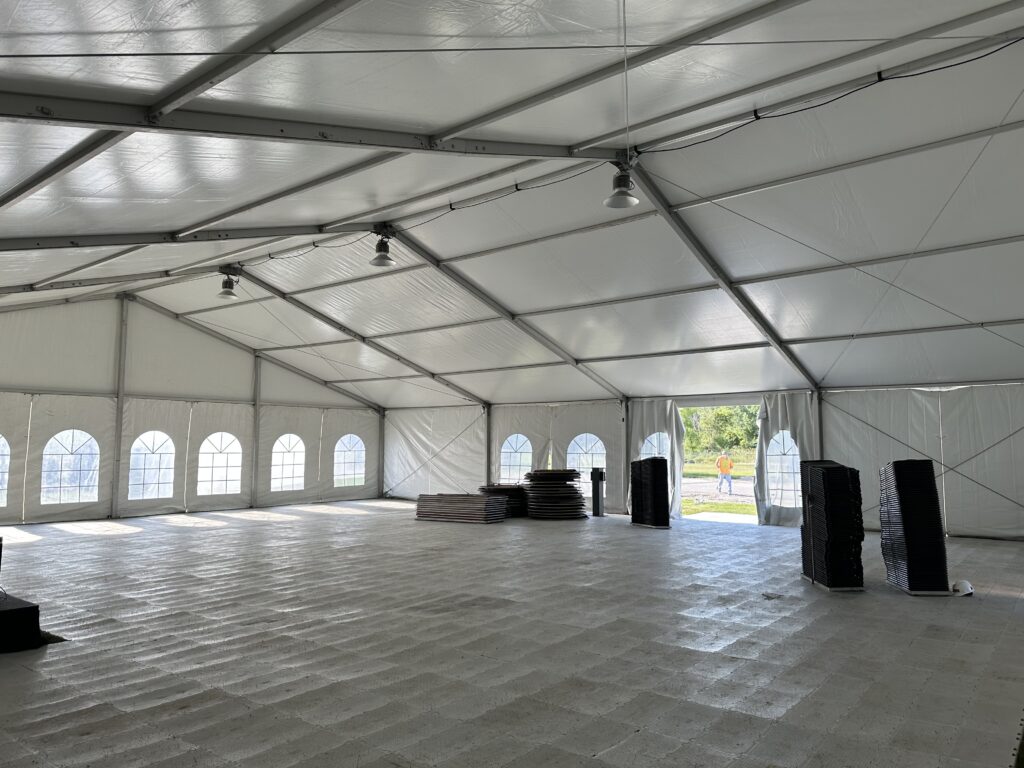 Under the 60′ x 66′ (18m x 20m) Losberger Clearspan Structure Temporary Tent with temporary subflooring and LED high-bay lights