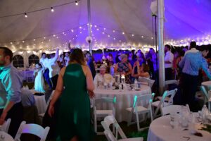Wedding guests under the 60' x 90' Legend rope and pole tent.