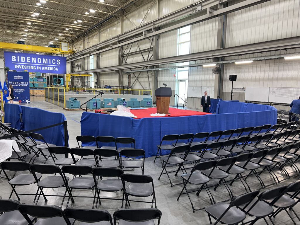 Chairs, stage, and barricade for presidential event "Bidenomics Investing In America in Milwaukee, Wisconsin"