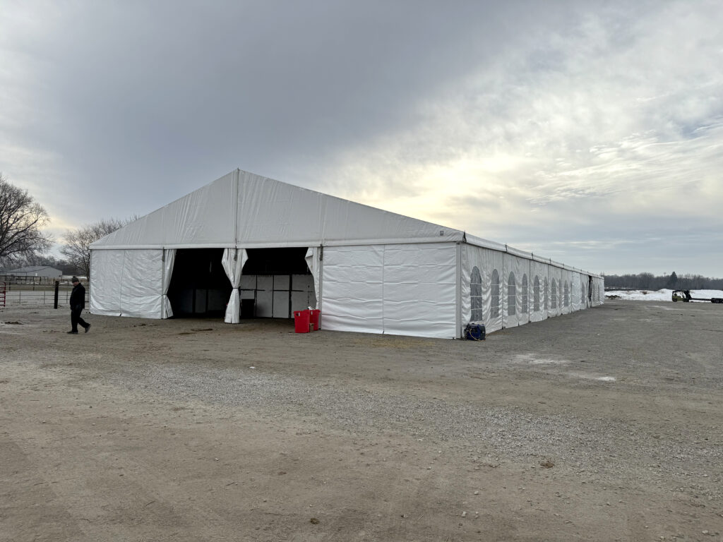 60' x 180' Clearspan Temporary Event Structure for the Special Workhorse Sale Kalona, Iowa in 2024. Front end with a person.