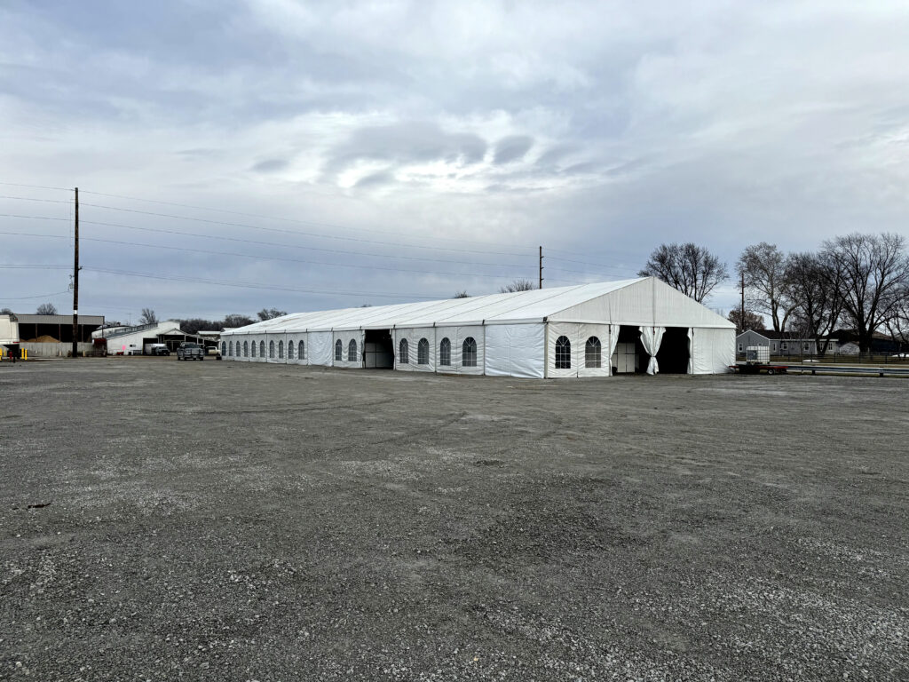 60' x 180' Clearspan Temporary Event Structure for the Special Workhorse Sale Kalona, Iowa in 2024 with a truck at the end.