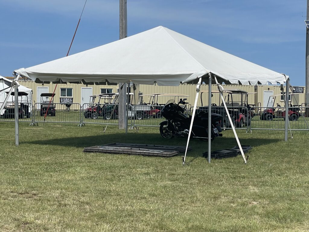 20' x 20' frame tent with tables and chairs ready to be set up - 2024 NASCAR Race Weekend at Iowa Speedway in Newton, Iowa