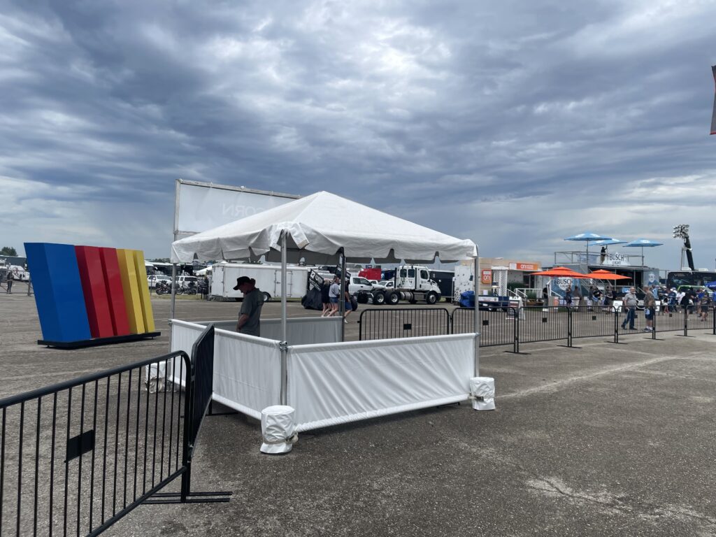 Information tent with pony walls (10' x 10' frame tent) - 2024 NASCAR Race Weekend at Iowa Speedway in Newton, Iowa