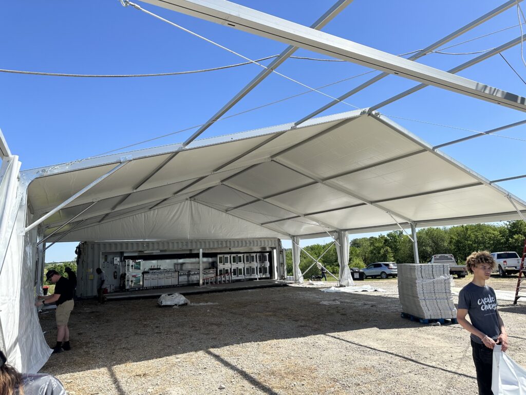 Setting up the 50' x 66' clearspan event structure - 2024 NASCAR Race Weekend at Iowa Speedway in Newton, Iowa - Liri tent