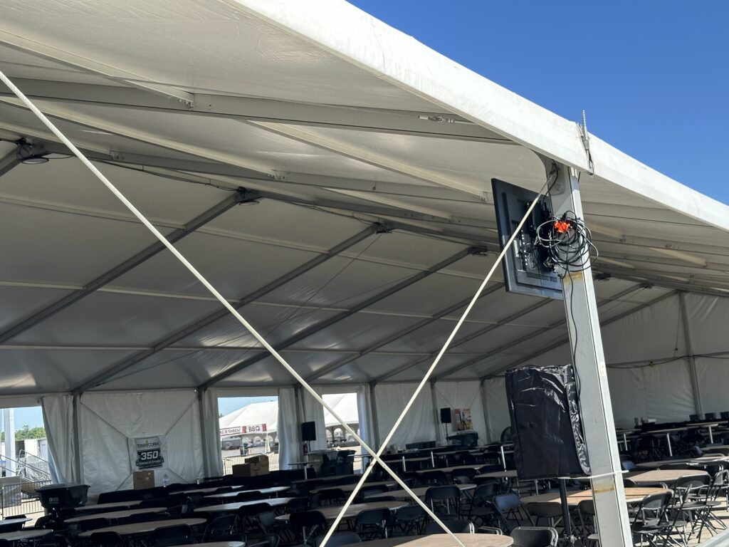 TVs, tables and chairs under 60' x 147' clearspan structure - 2024 NASCAR Race Weekend at Iowa Speedway in Newton, Iowa