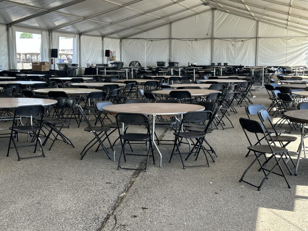 Tables and chairs under - 2024 NASCAR Race Weekend at Iowa Speedway in Newton, Iowa - Liri tent