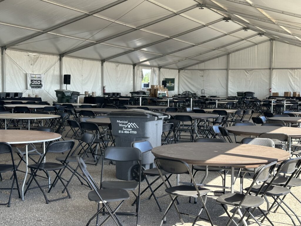Tables and chairs under clearspan tent - 2024 NASCAR Race Weekend at Iowa Speedway in Newton, Iowa - Liri tent