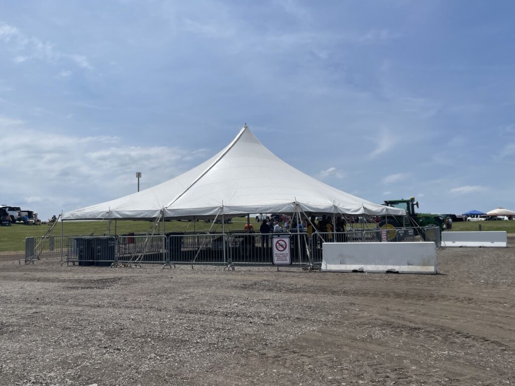 Tram Schedule waiting tent with a 40' x 40' rope and pole tent - 2024 NASCAR Race Weekend at Iowa Speedway in Newton, Iowa