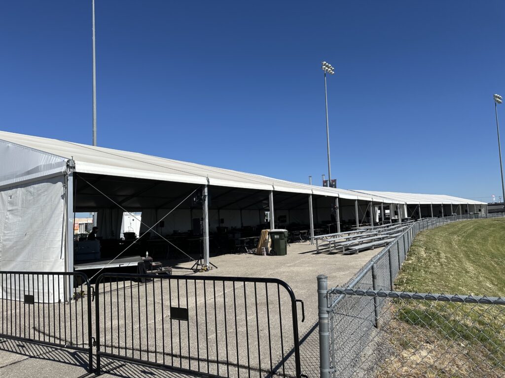 Two clearspan event structures overlooking the NASCAR Race on the Iowa Speedway racetrack - Left is a 60' x 162' clearspan event tent and on the right is a 60' x 147' clearspan structure
