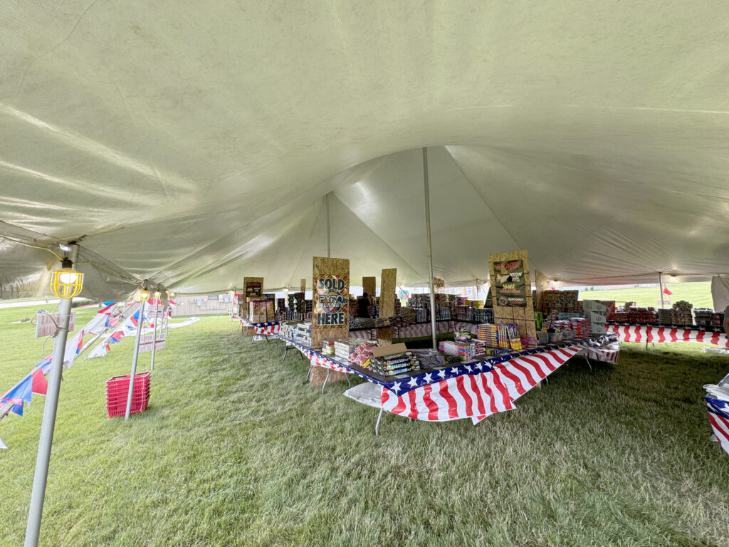 Under the fireworks tent in North Liberty, Iowa with lots of fireworks for sale.30' x 40' Rope and Pole Tent.